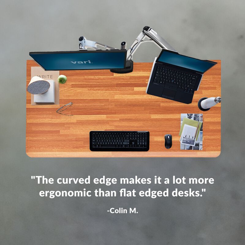 colin m. stated the curved edge makes it a lot more ergonomic than flat edged desks under an overhead image of a desk image number null